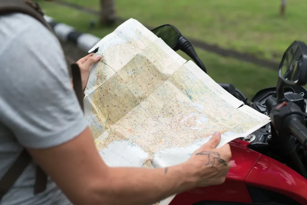 A person holding a smartphone with a map application open, symbolizing navigation challenges linked to a wrong tour guide.